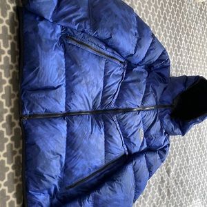 A Nike blue coat has like little stripes it has been use